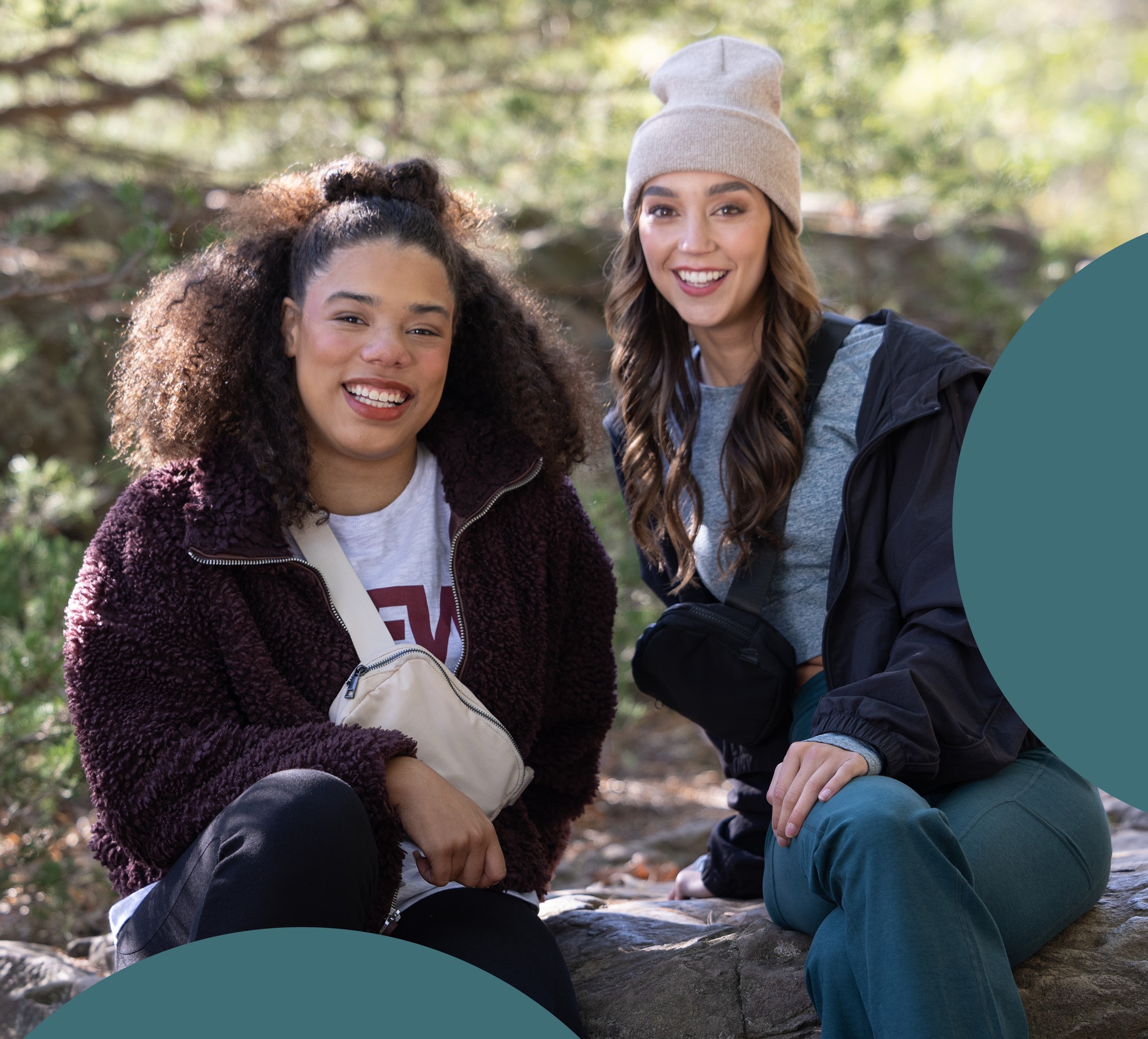 2 GIRLS SITTING ON ROCK